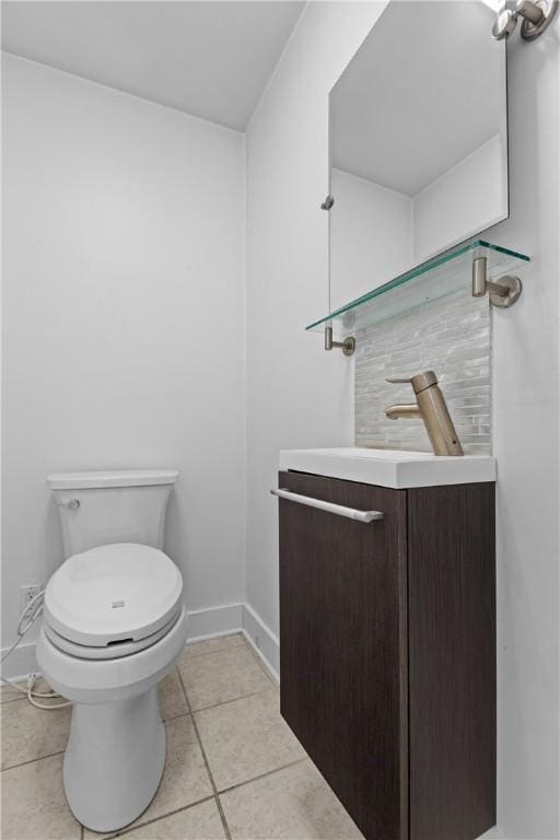 bathroom featuring tile patterned flooring, vanity, and toilet