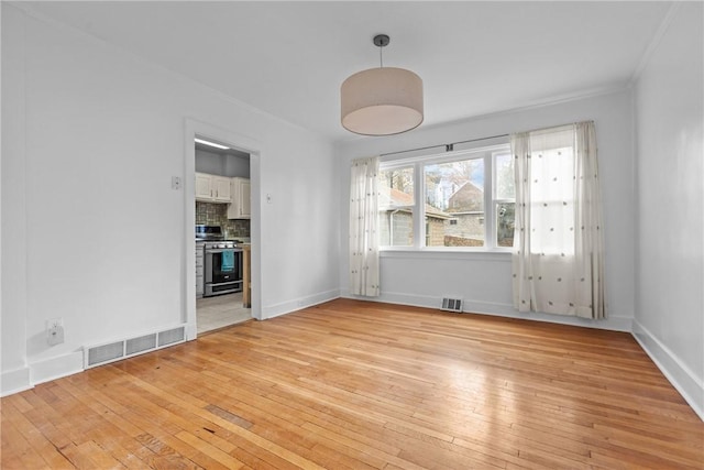 spare room with light hardwood / wood-style floors and ornamental molding