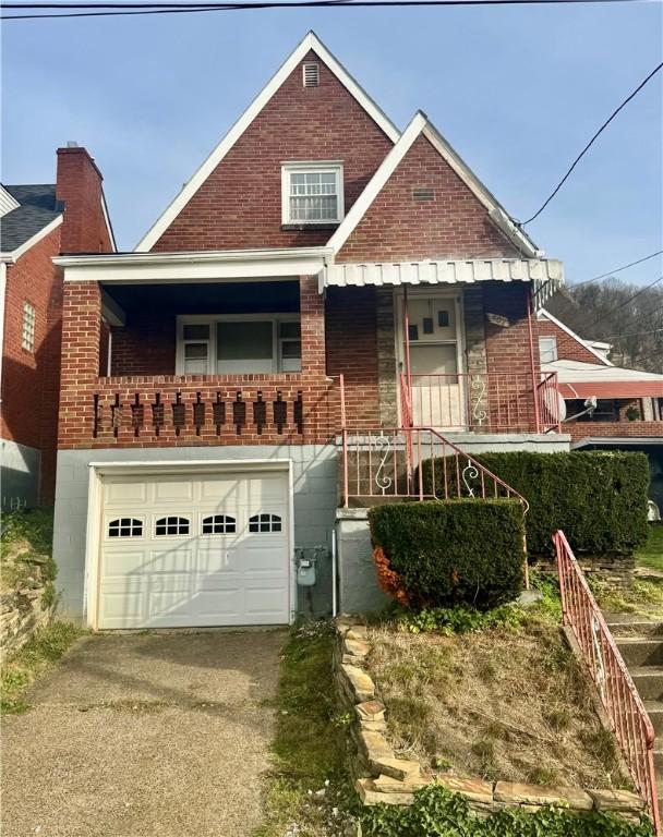 view of front of property featuring covered porch and a garage