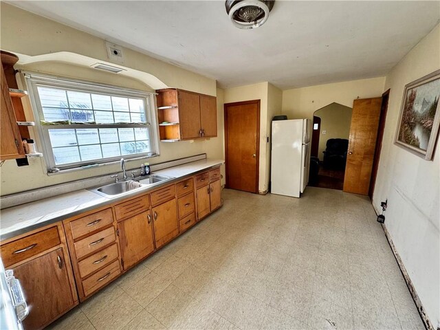 kitchen with white refrigerator and sink