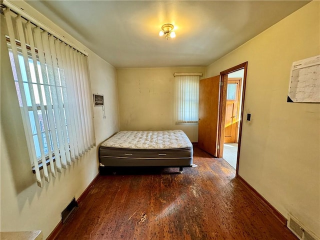 bedroom with dark wood-type flooring