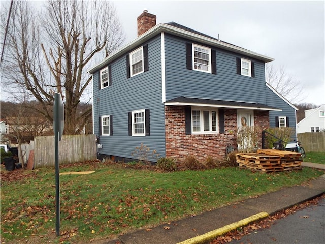 view of property featuring a front lawn