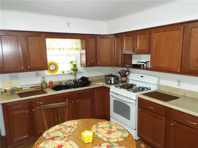 kitchen featuring sink and white gas range oven