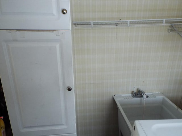 washroom with sink and washer / clothes dryer