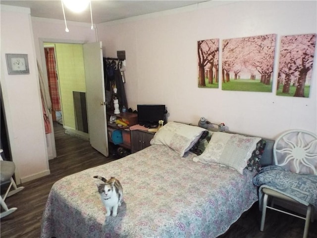 bedroom with dark hardwood / wood-style floors