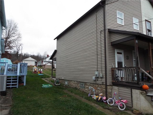 view of property exterior featuring a deck and a yard