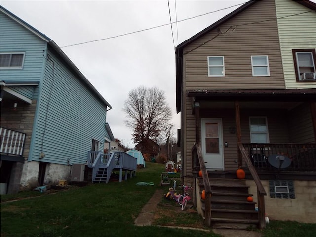 409 1st St, East Bethlehem, PA 15368 - view of home's exterior with covered porch, a lawn, stairs, and cooling unit