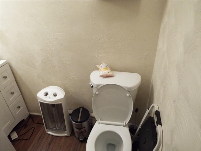 bathroom with hardwood / wood-style flooring and toilet