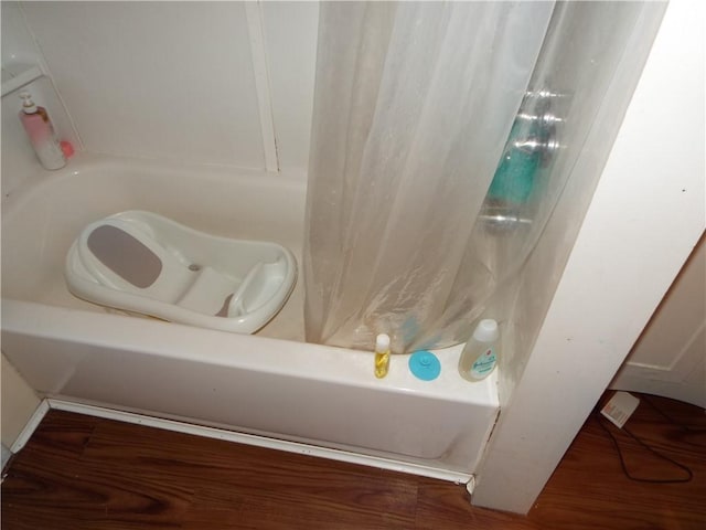 409 1st St, East Bethlehem, PA 15368 - bathroom with shower / bath combo with shower curtain and wood finished floors