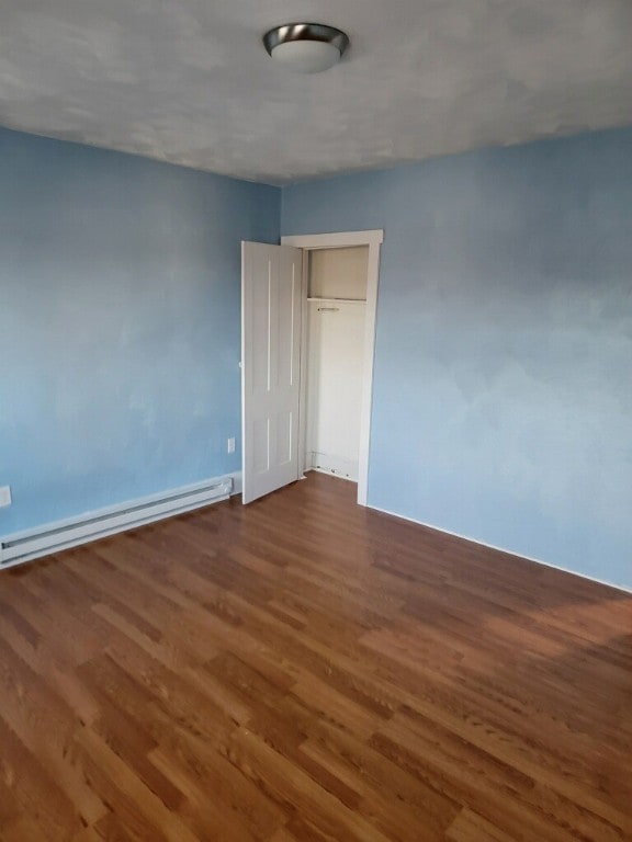 409 1st St, East Bethlehem, PA 15368 - spare room featuring wood finished floors, baseboard heating, and baseboards