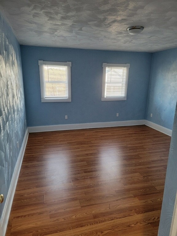409 1st St, East Bethlehem, PA 15368 - unfurnished room featuring plenty of natural light, wood finished floors, baseboards, and a textured ceiling