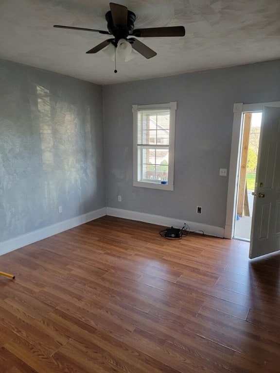 empty room featuring ceiling fan and dark wood-type flooring