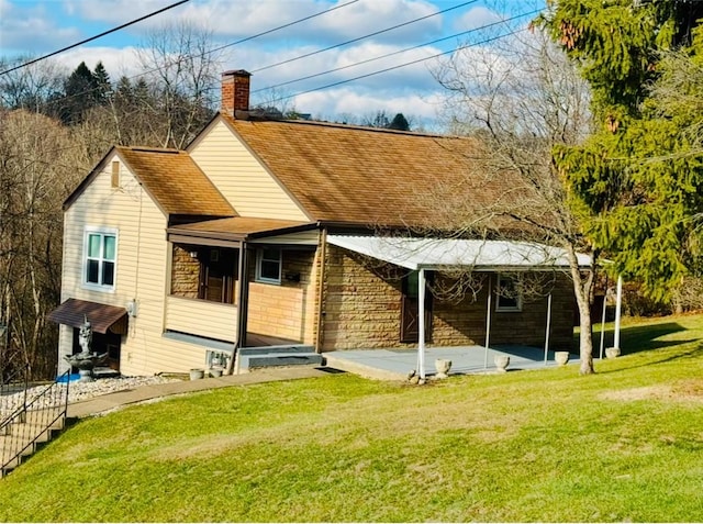 rear view of house with a yard and a patio