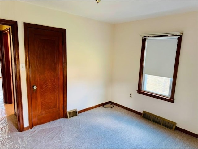 unfurnished bedroom featuring light colored carpet