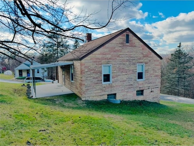 view of home's exterior featuring a lawn and a patio area