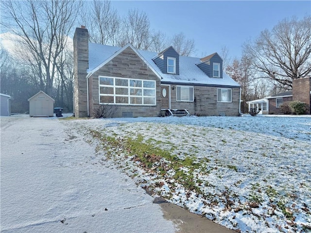 view of front of property with a storage shed