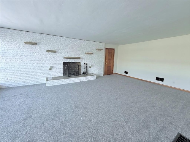 unfurnished living room featuring carpet flooring and a fireplace