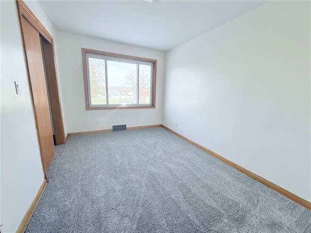 unfurnished bedroom featuring carpet and a closet