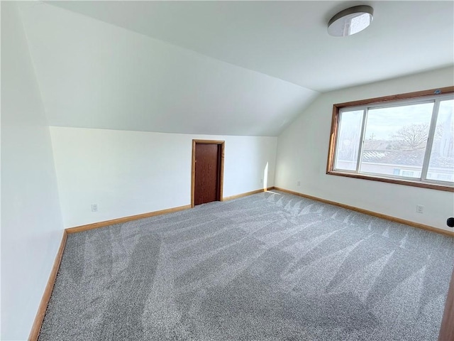 bonus room with carpet floors and lofted ceiling