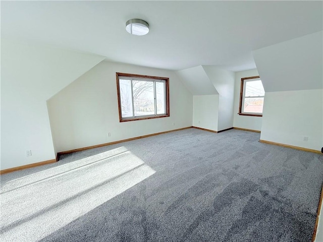 bonus room with carpet flooring and lofted ceiling