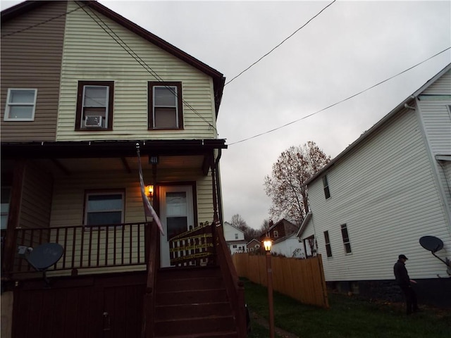 rear view of house featuring covered porch