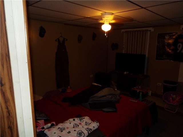 bedroom with a paneled ceiling and ceiling fan