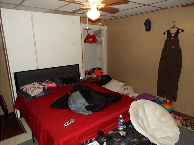 bedroom featuring ceiling fan and a drop ceiling