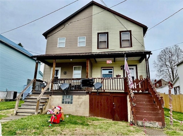 view of front of house with covered porch, fence, and stairs