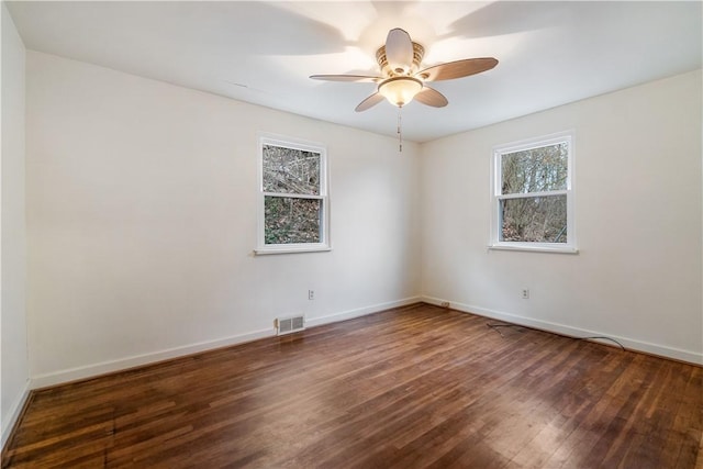 unfurnished room with ceiling fan and dark wood-type flooring