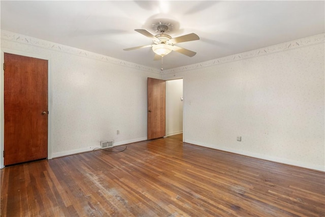 spare room featuring ceiling fan and dark hardwood / wood-style flooring