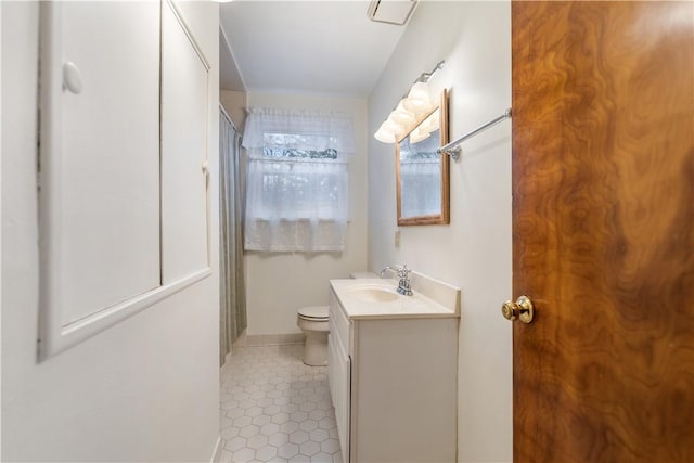 bathroom with tile patterned floors, vanity, and toilet