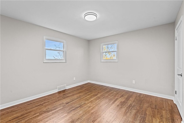 unfurnished room with wood-type flooring