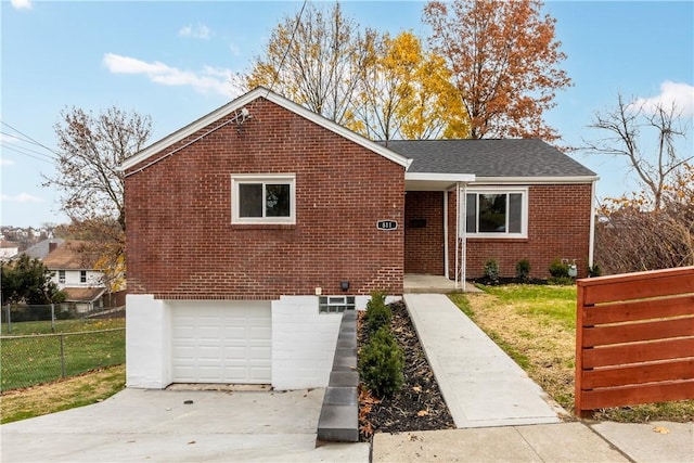 view of front of house with a garage and a front yard