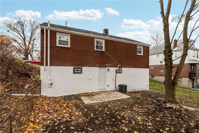 rear view of house featuring cooling unit