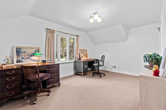 carpeted home office with vaulted ceiling