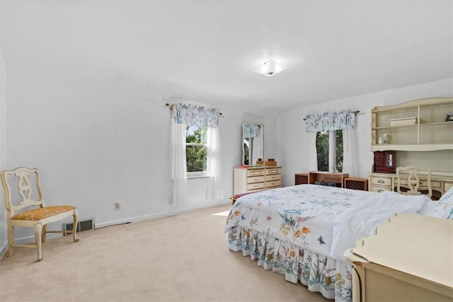 bedroom featuring multiple windows and light carpet