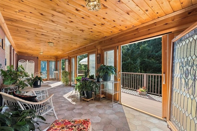 unfurnished sunroom featuring wood ceiling