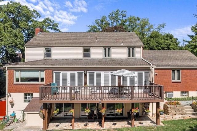 back of property featuring a patio, a deck, and a wall unit AC