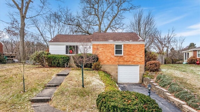 view of front facade with a front yard and a garage