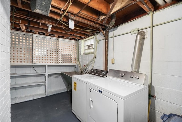 clothes washing area featuring sink and washing machine and clothes dryer