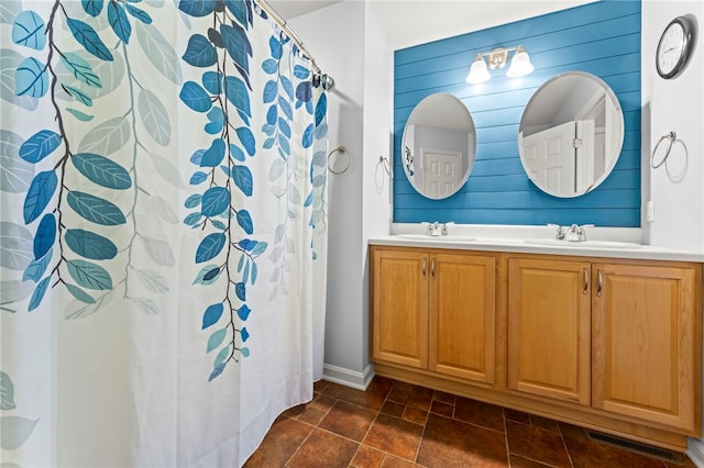 bathroom with vanity, walk in shower, and wood walls