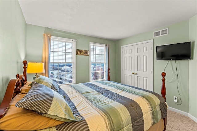 carpeted bedroom with a closet