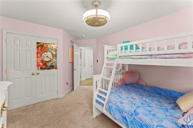 bedroom with light carpet and a closet