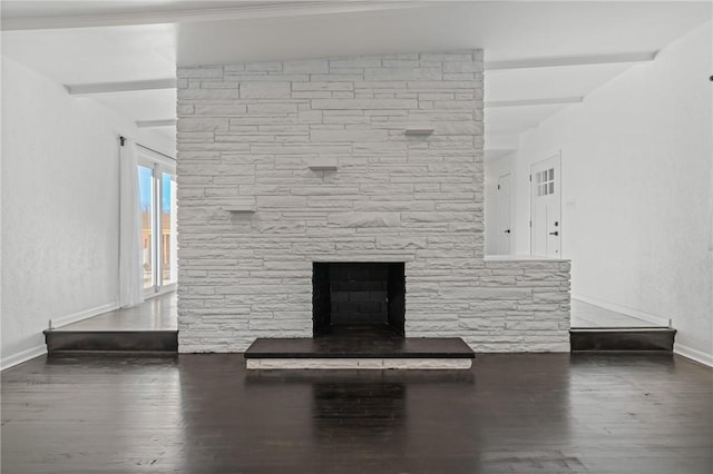 interior details with a stone fireplace, beamed ceiling, and hardwood / wood-style flooring