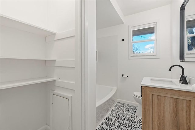 bathroom with tile patterned floors, vanity, and toilet