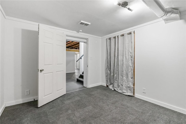 unfurnished bedroom with dark colored carpet