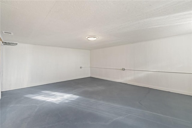 unfurnished room featuring a textured ceiling