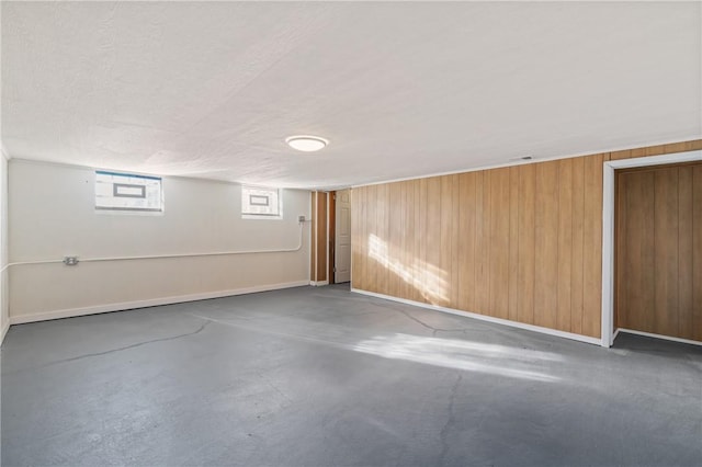 basement featuring wooden walls