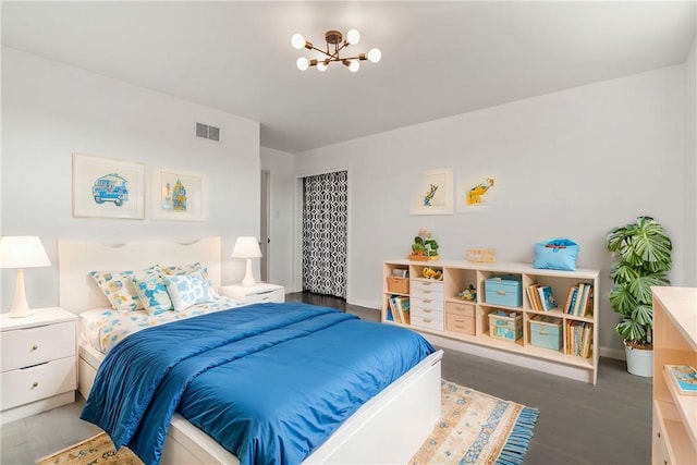 bedroom with a chandelier and dark hardwood / wood-style flooring