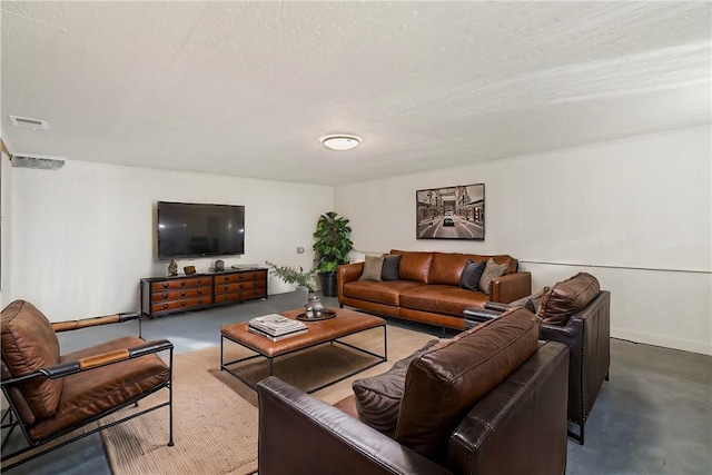 living room with concrete flooring and a textured ceiling